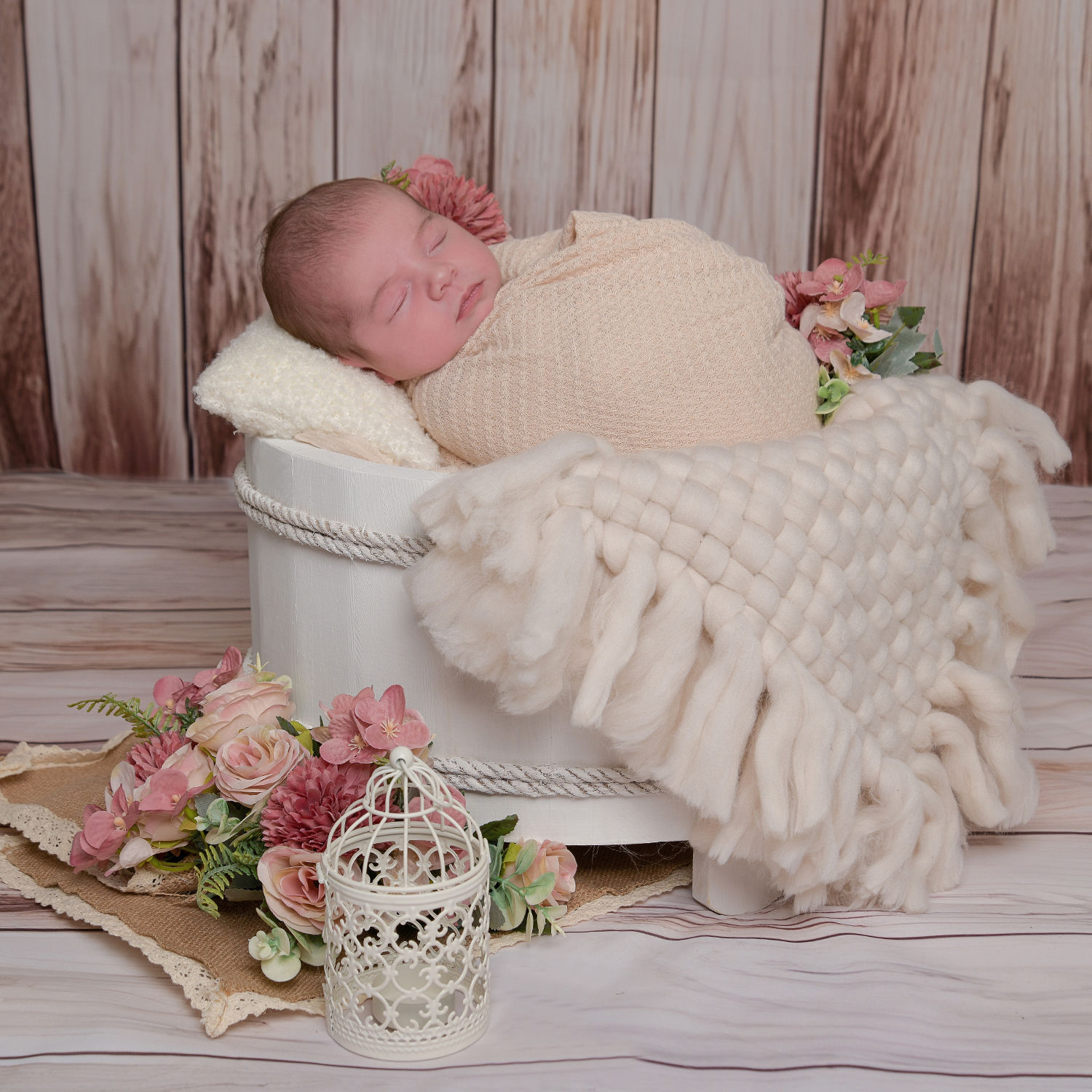Newborn wrapped in soft pink blanket