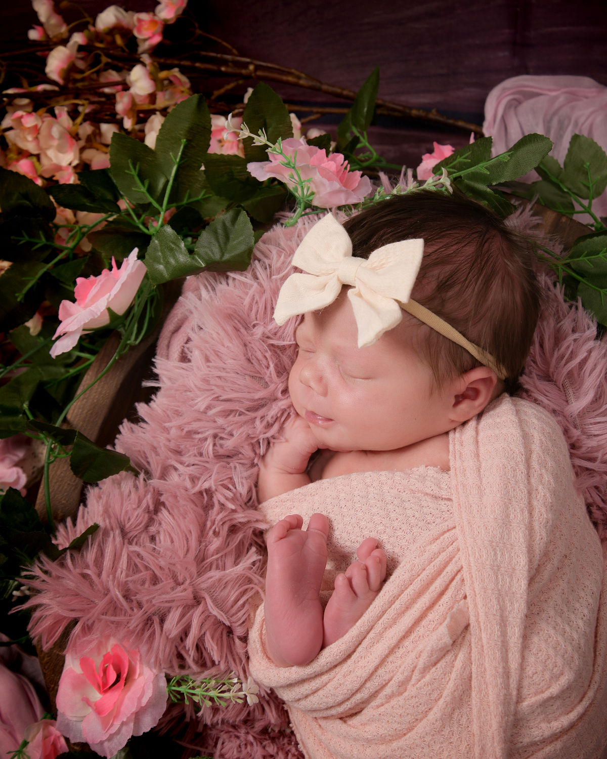 Sleeping newborn surrounded by florals